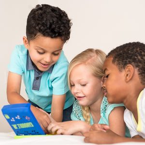 Three children arranging pieces to solve Kanoodle Jr.