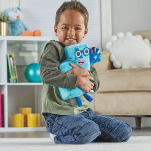 A child hugging a Numberblocks Number Five Plush